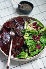 Wall Mural - Healthy salad with beets and fresh leaves. Slimming salad with olive oil and lemon juice, beets and lettuce.