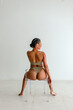 © Erin Brant/Stocksy - Rear view of woman sitting in chair