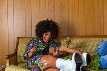Lovely African American Couple Laughing And Eating Grapes 