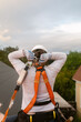 © ByLorena/Stocksy - Roofer putting on harness safety