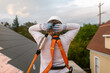 © ByLorena/Stocksy - Female builder roofer putting on safety gear