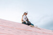© ByLorena/Stocksy - Woman roofer working on sustainable roof