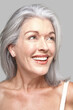 © Trinette Reed/Stocksy - Close-up portrait of mature woman smiling looking up