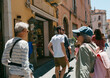 © Jimena Roquero/Stocksy - Group of tourists walking on a street of Taormina village in Sicily