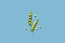 Organic Ripe Green Peas And Pods On Blue Background