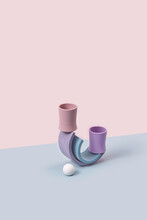 Two Pastel Colored Kids Cup Balancing On Arched Ramps