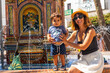 © unai - A tourist with her son at the water fountain in the plaza de españa in Vejer de la Frontera, Cadiz