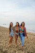 © Jovo Jovanovic/Stocksy - Girlfriend smiling and embracing each other at the beach