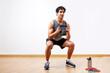 © ALTO IMAGES/Stocksy - Glad sportsman doing kettlebell goblet squat