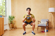 © ALTO IMAGES/Stocksy - Positive Hispanic sportsman squatting with kettlebell