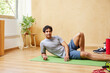 © ALTO IMAGES/Stocksy - Content guy relaxing on mat after training at home