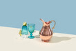 © Yaroslav Danylchenko/Stocksy - Copper jug and glass of fresh lime drink and ice.