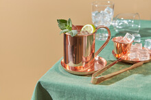 Copper Cup Of Fresh Lemonade With Ice Tongs.