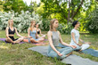 © Andriy Bezuglov/Stocksy - Group of young women practice yoga in park on summer sunny morning