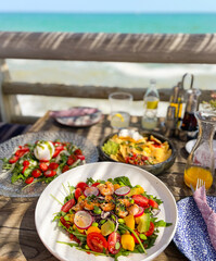 Beautiful lunch at the wood table with a fantastic view to the blue sea