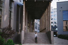 Businessman Standing Near Company Building 