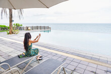 Woman Relaxed And Took Photo Near Infinity Pool