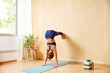 © ALTO IMAGES/Stocksy - Female doing Headstand variation in morning