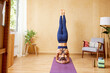 © ALTO IMAGES/Stocksy - Woman doing Salamba Sirsasana in morning