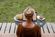 © Milles Studio/Stocksy - Anonymous female using laptop in weekend on terrace