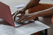 © Milles Studio/Stocksy - Crop black freelancer typing on laptop keyboard