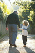 © Trinette Reed/Stocksy - Grandfather and grandson walking holding hands