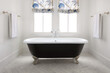 © Trinette Reed/Stocksy - Farmhouse bathroom with clawfoot bathtub and blinds