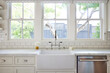© Trinette Reed/Stocksy - Farmhouse sink in modern home kitchen