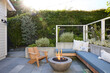 © Trinette Reed/Stocksy - Modern design deck patio with outdoor fireplace pit and bench