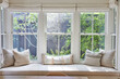 © Trinette Reed/Stocksy - Window seat in modern design farmhouse home