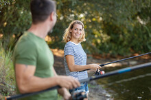 Beautiful Couple Catching Fish In The Pond