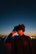 © Ezequiel Giménez/Stocksy - Male gamer in VR goggles on terrace in evening