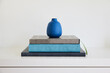 © Trinette Reed/Stocksy - Books and vase on shelf in home
