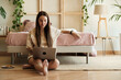 © Malquerida Studio/Stocksy - Gen z woman using laptop at home