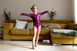 © Eloisa Ramos/Stocksy - little girl practicing artistic gymnastics at home