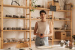 © Brkati Krokodil/Stocksy - Portrait Of A Female Shop Owner Holding A Ceramic Cup