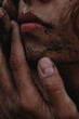 © Anastasia Mihaylova (Shpara)/Stocksy - A woman's portrait Close Up with red lips and back sand on the face