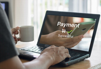 Online shopping and online payment concept. Man hands using laptop computer for online shopping at home, Hand holding coffee cup and make Payment Detail page display on computer laptop.