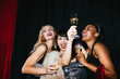 © BONNINSTUDIO/Stocksy - Stylish ladies with champagne glasses celebrating Xmas