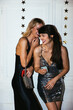 © BONNINSTUDIO/Stocksy - Stylish happy ladies chatting during Xmas party