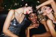 © BONNINSTUDIO/Stocksy - Gorgeous diverse ladies smiling during Christmas party