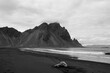 © Anastasia Mihaylova (Shpara)/Stocksy - Naked woman sitting on the beach in sand near the rocks in Iceland