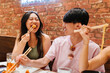 © VICTOR TORRES/Stocksy - Smiling chinese friends eating delicious food in restaurant