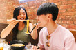 © VICTOR TORRES/Stocksy - Cheerful chinese couple eating noodles and ramen in cafe