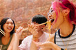 © VICTOR TORRES/Stocksy - Young chinese woman eating noodles with friends