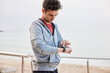 © Martí Sans/Stocksy - Young male athlete using smart watch