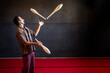 © Albert Martinez/Stocksy - Attentive Hispanic man juggling clubs during rehearsal