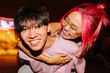 © VICTOR TORRES/Stocksy - Cheerful chinese couple making piggyback at night