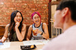© VICTOR TORRES/Stocksy - Cheerful friends waiting for lunch in restaurant
