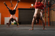 © Ibai Acevedo/Stocksy - Crossfit athletes practicing handstand walk